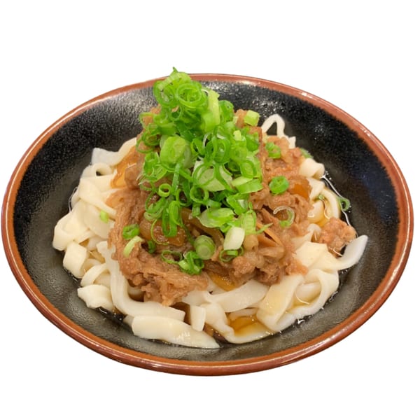 A bowl of Sapporo Ramen & Sushi's ramen with flat noodles, beef, and green onions.